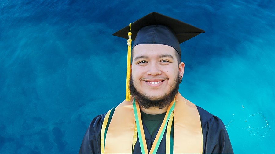 Andres Camacho portrait in graduation regalia