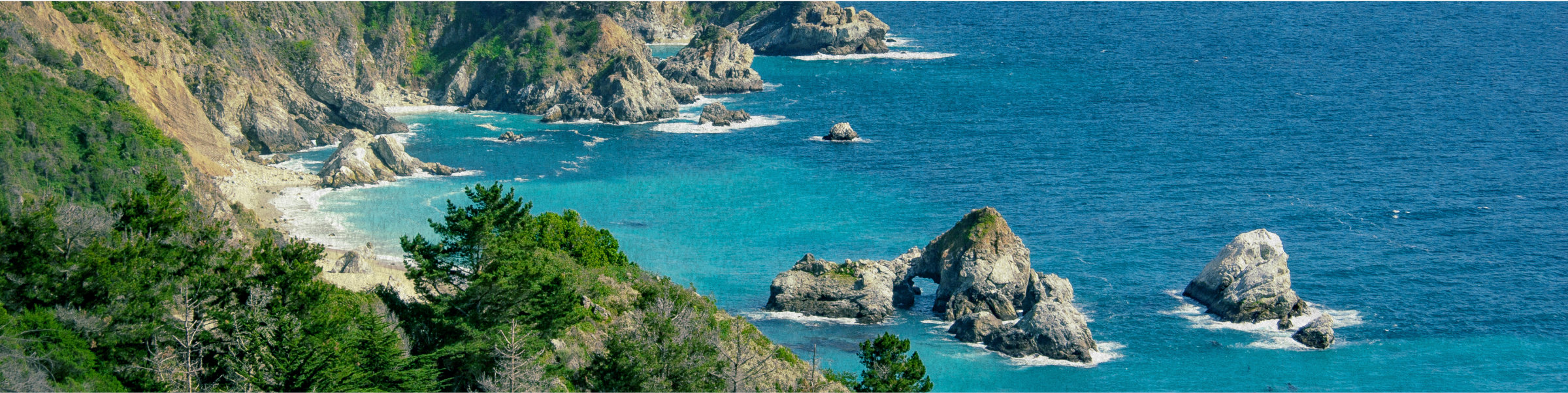 Blue water rocks and beach of Big Sur coast